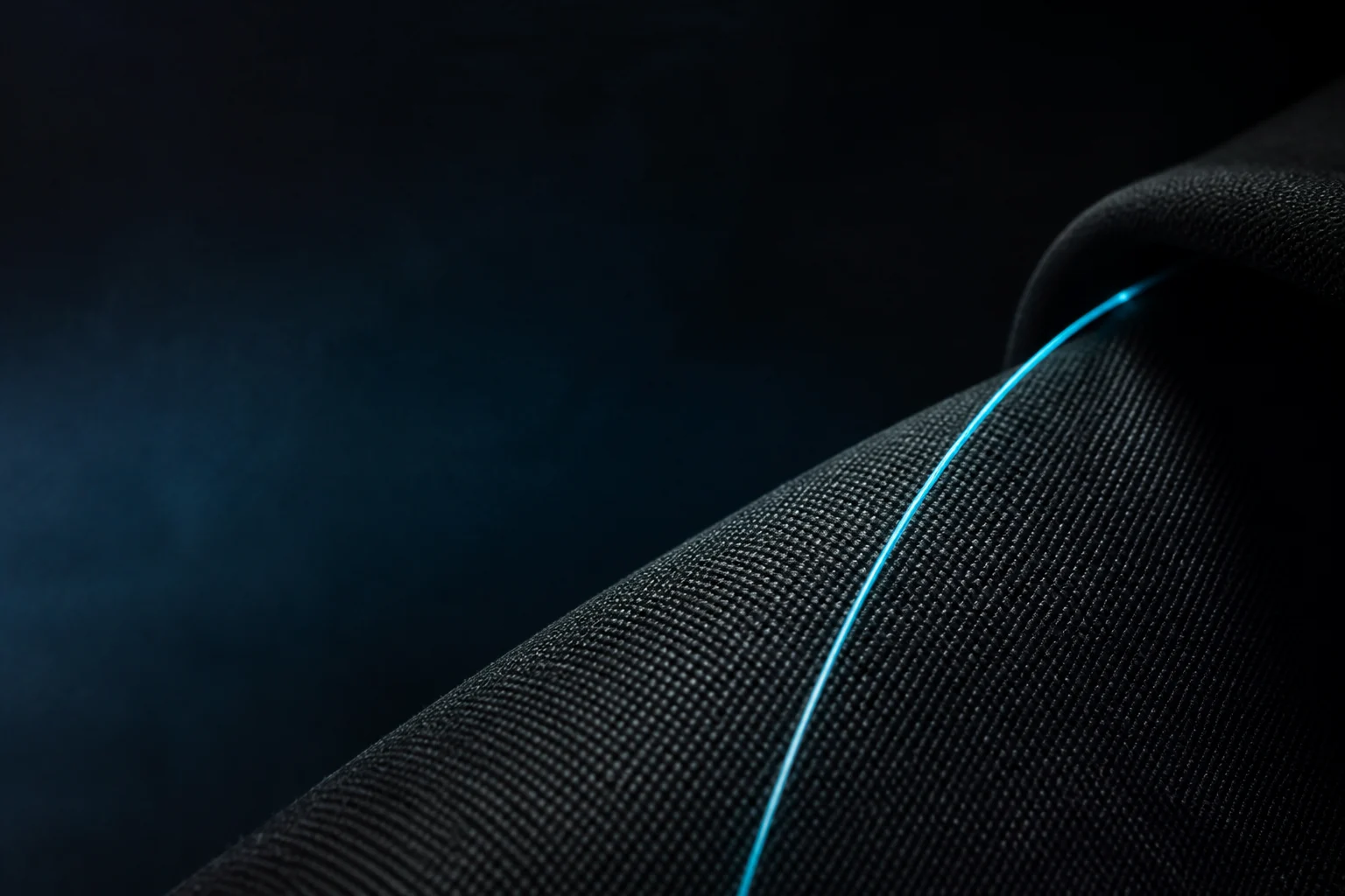 Graphite technical fabric with a subtle cyan fiber-optic line
